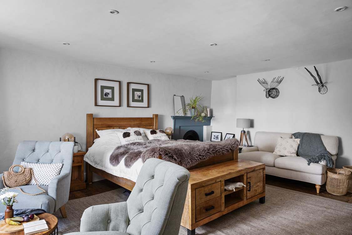 A bedroom of dreams with lots of seating options.
