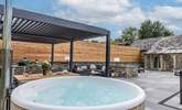The outdoor cooking/dining and seating area complete with a wood-fired hot tub. - Thumbnail Image