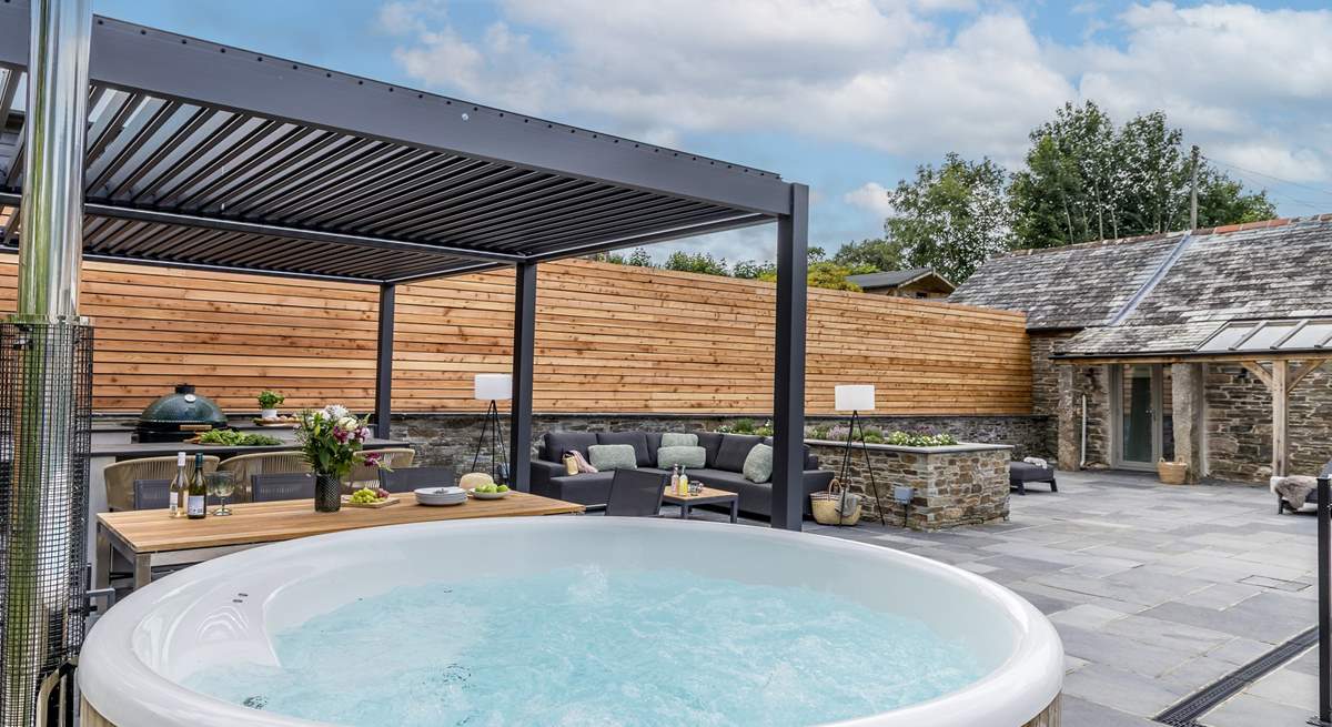The outdoor cooking/dining and seating area complete with a wood-fired hot tub.