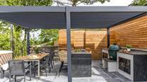 What could be better than cooking a feast in the outdoor kitchen and dining al fresco under the bespoke pergola.