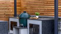 The granite worktops offer a luxurious finish to the outdoor kitchen.