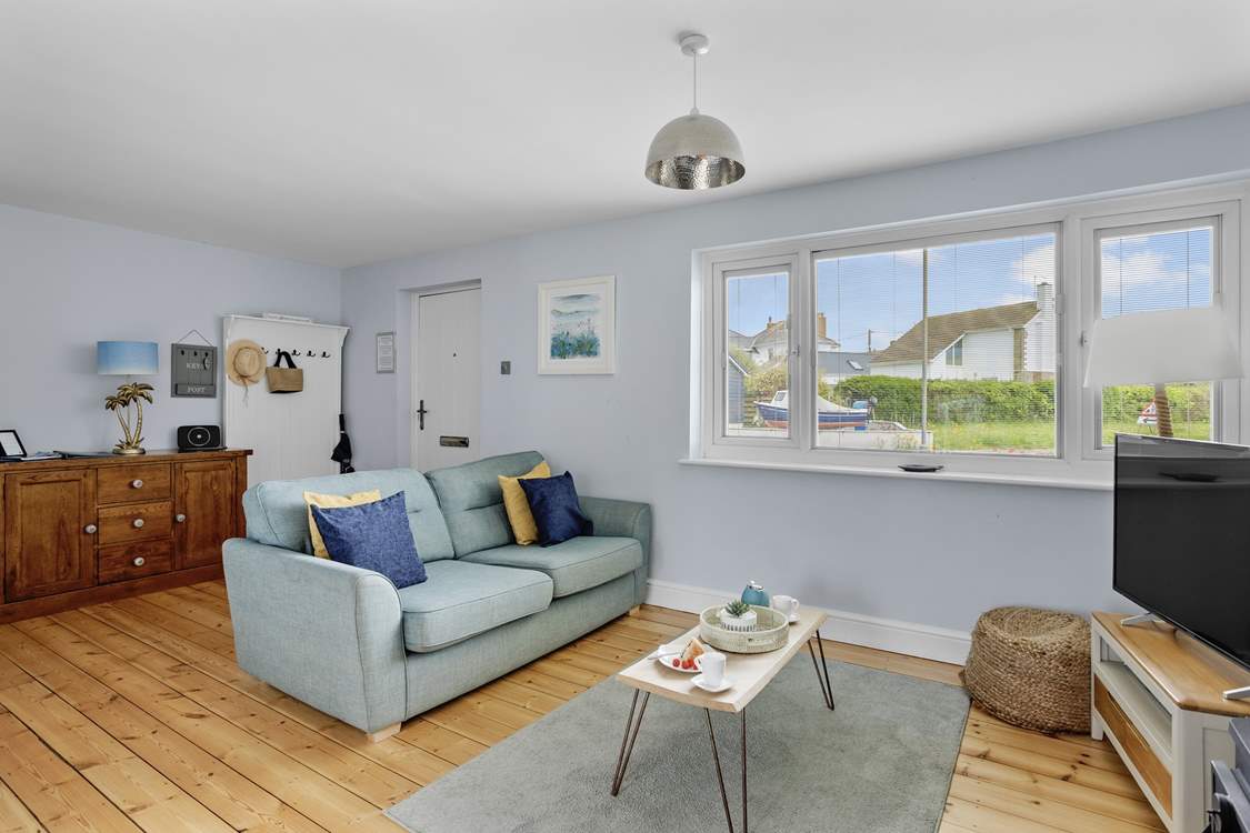 The sitting/dining room offers the perfect social area for the family to come together after a day at the beach.