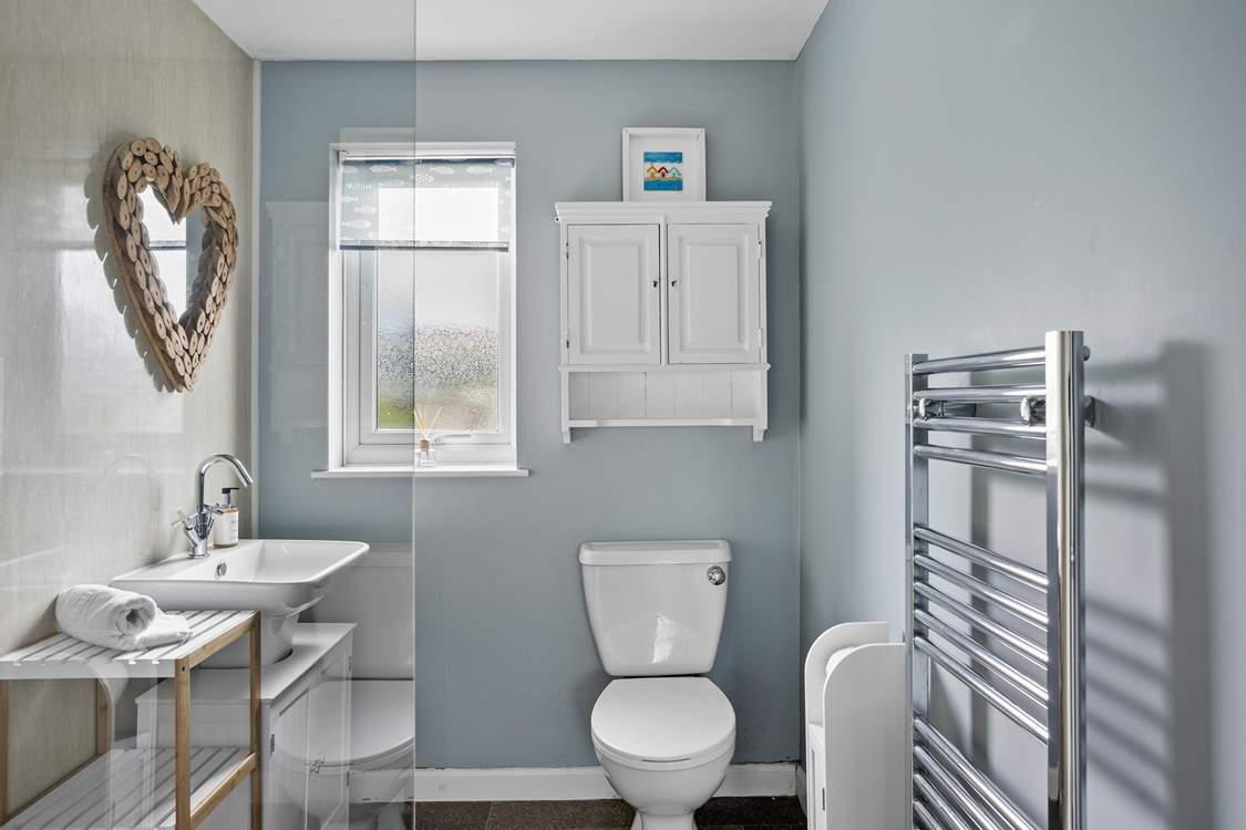The modern family shower-room is shared by both bedrooms.