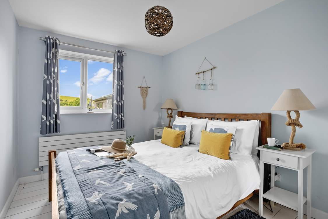 Bedroom 1 offers a coastal nod to its surroundings.
