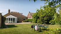 Looking down the garden by the shade of the mature trees..
