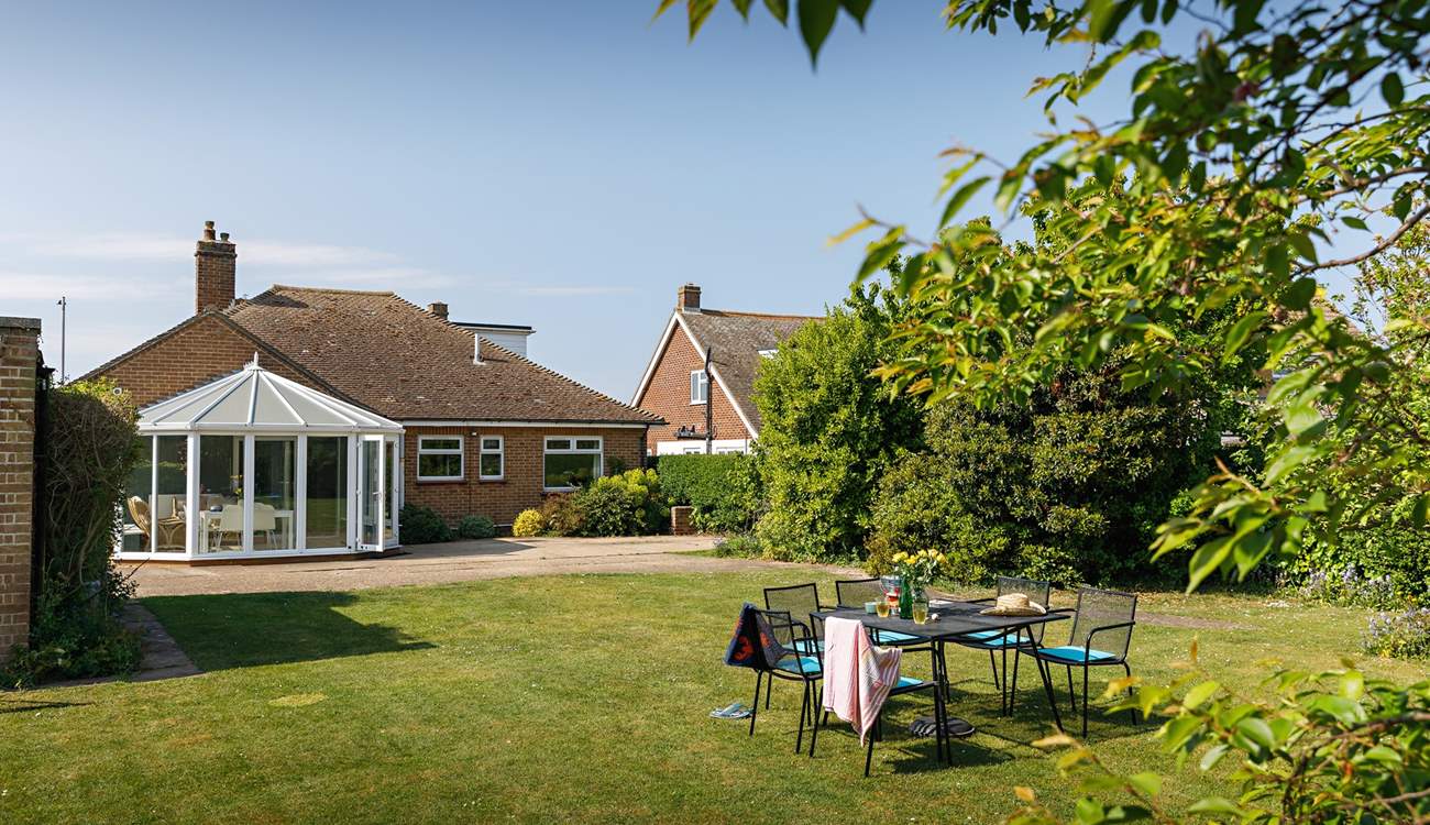 Looking down the garden by the shade of the mature trees..