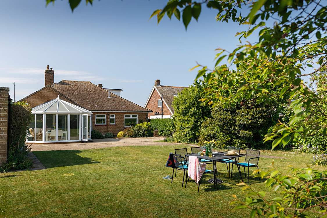 Looking down the garden by the shade of the mature trees..