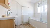 The upstairs bathroom is light and airy with privacy blind.