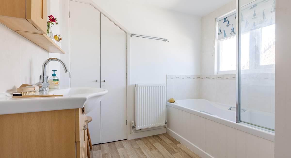The upstairs bathroom is light and airy with privacy blind.