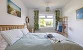 Relax and unwind in the light-filled downstairs bedroom, lovely views of the rear garden. - Thumbnail Image