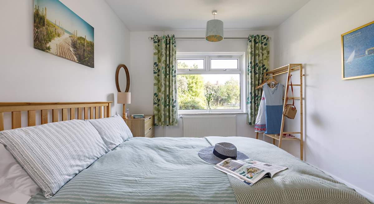 Relax and unwind in the light-filled downstairs bedroom, lovely views of the rear garden.