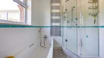A delightful corner shower in this spacious room.