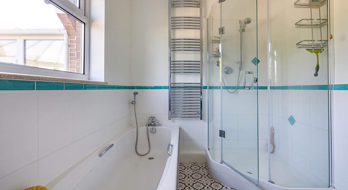 A delightful corner shower in this spacious room.