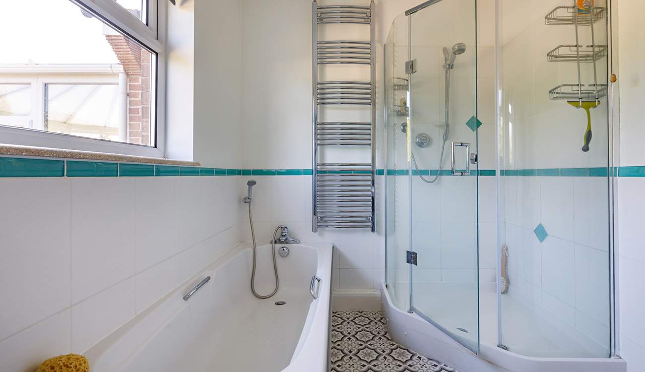 A delightful corner shower in this spacious room.