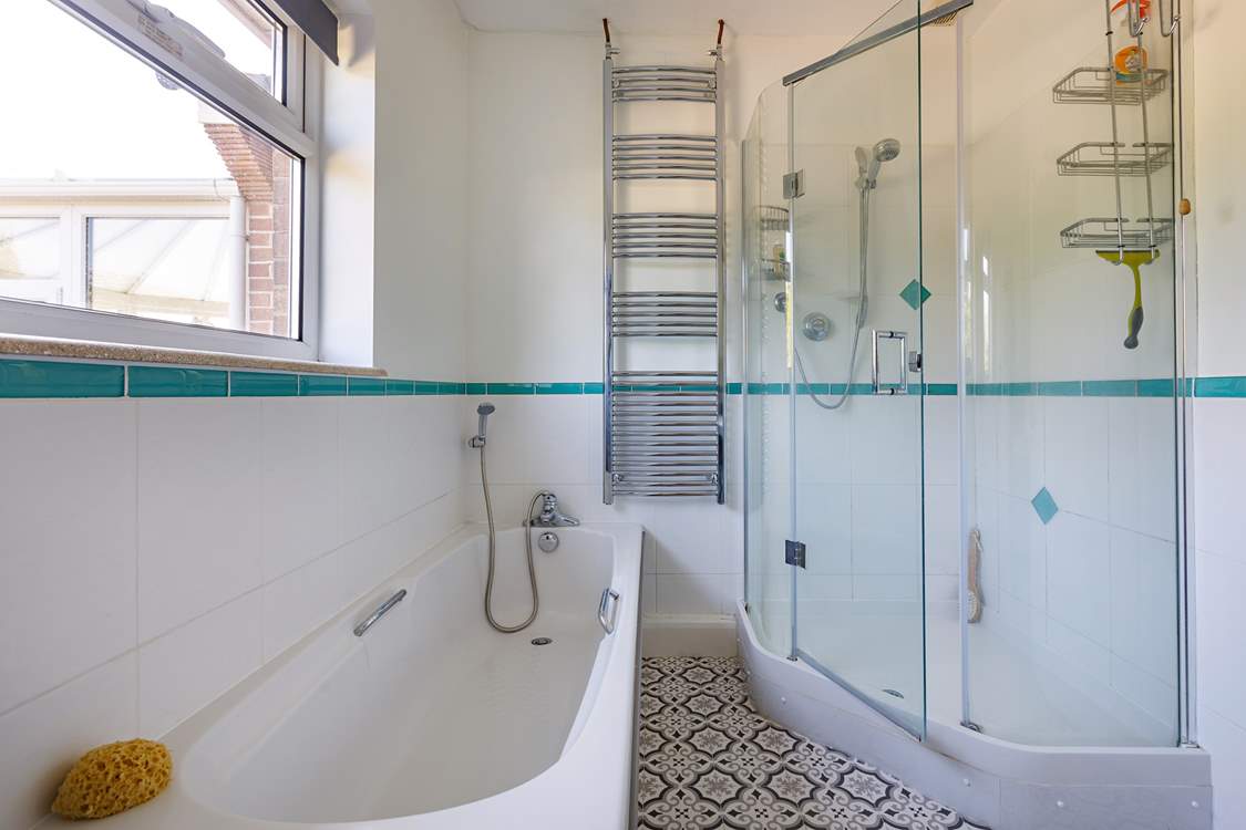A delightful corner shower in this spacious room.