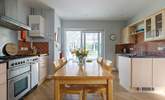 Look out into the conservatory from the light-filled kitchen. - Thumbnail Image