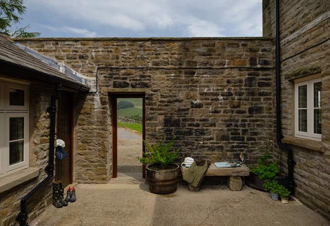 The courtyard leads out onto the garden and parking area. 