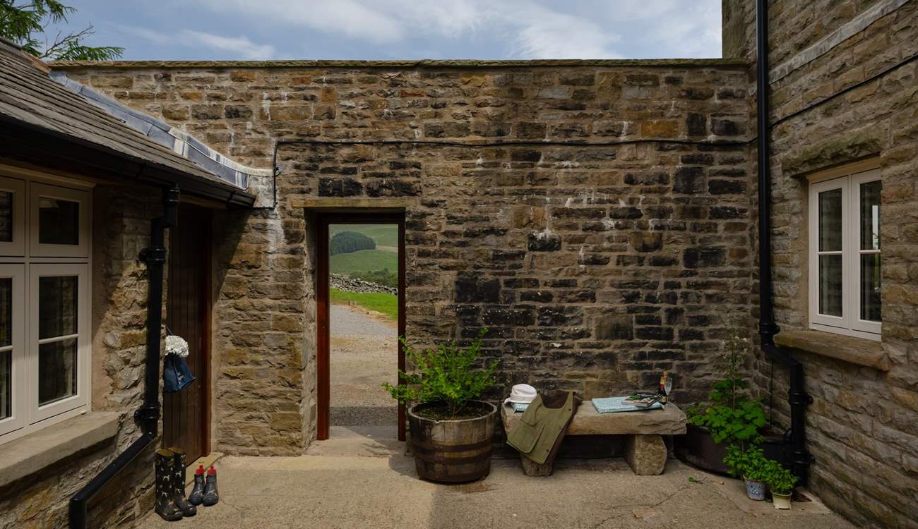 The courtyard leads out onto the garden and parking area. 