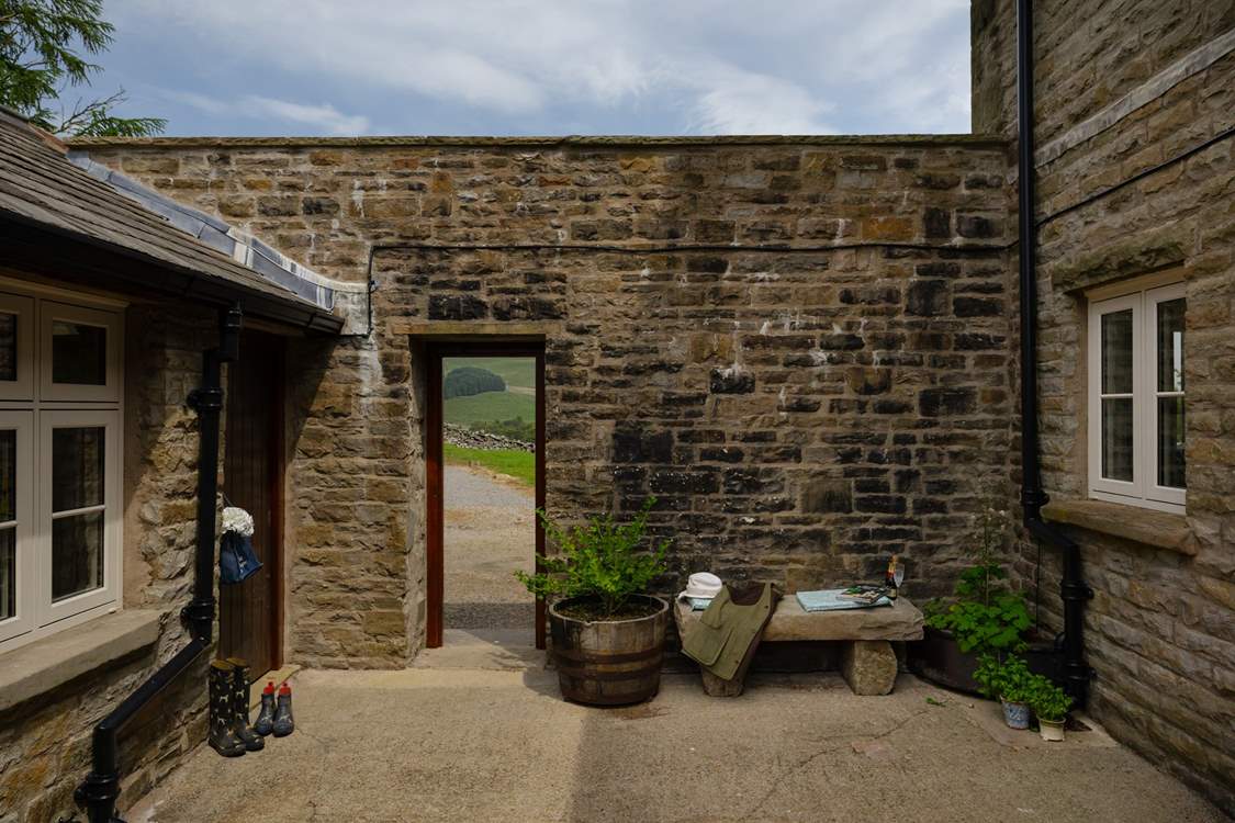 The courtyard leads out onto the garden and parking area.