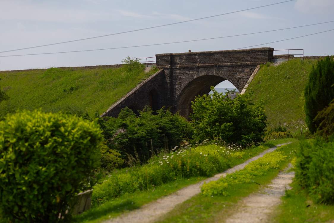 The lane in front of the cottage with the viaduct in view.