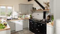A beautiful contemporary kitchen/diner with amazing views (the oil-fired Esse range cooker is ornamental only).