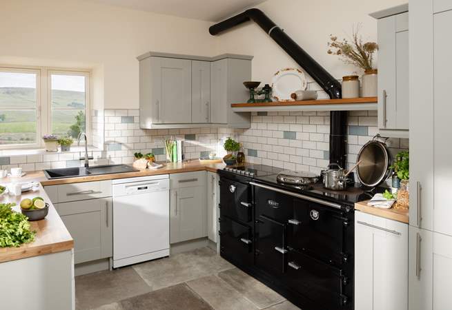 A beautiful contemporary kitchen/diner with amazing views (the oil-fired Esse range cooker is ornamental only).