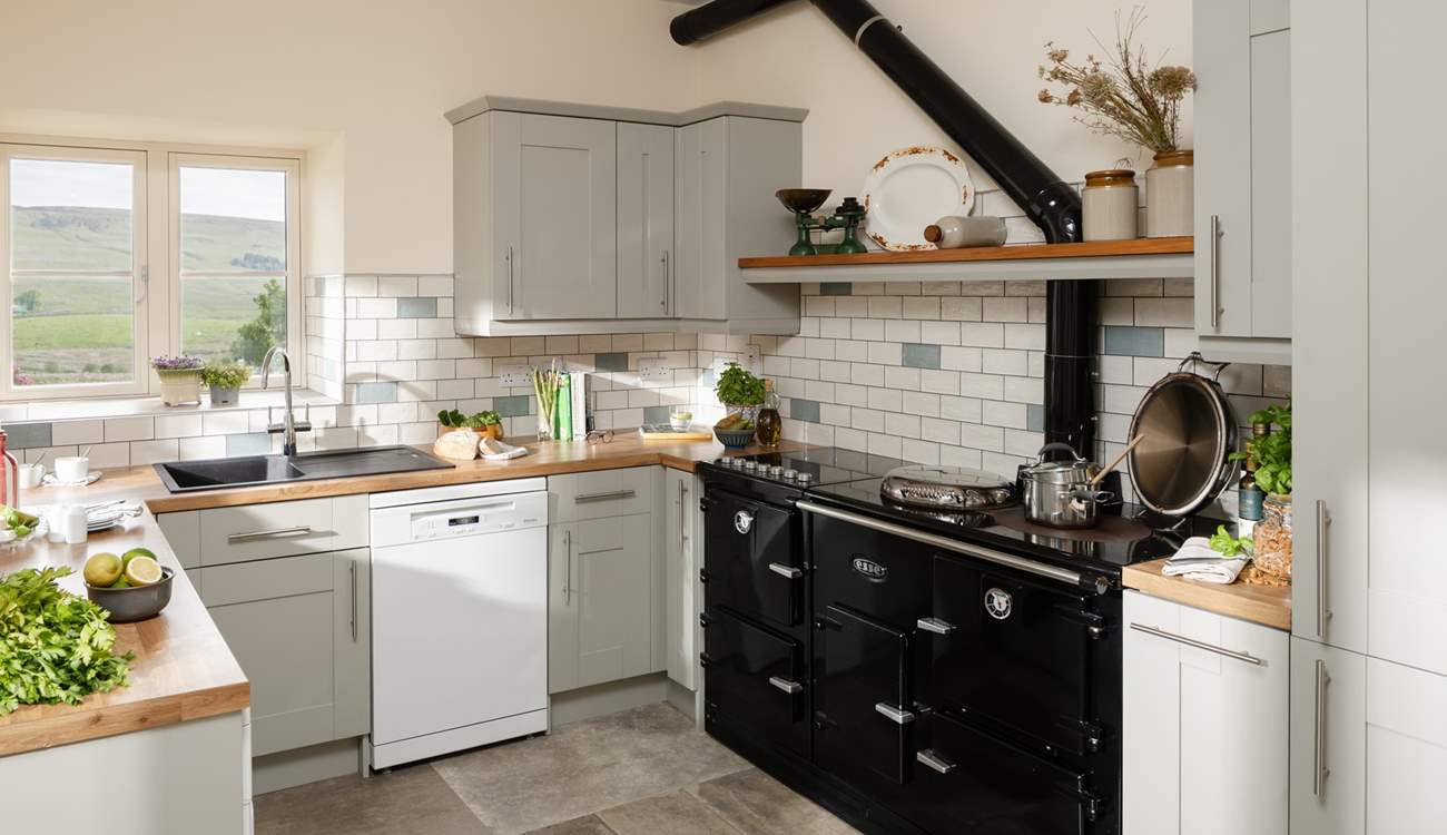 A beautiful contemporary kitchen/diner with amazing views (the oil-fired Esse range cooker is ornamental only).
