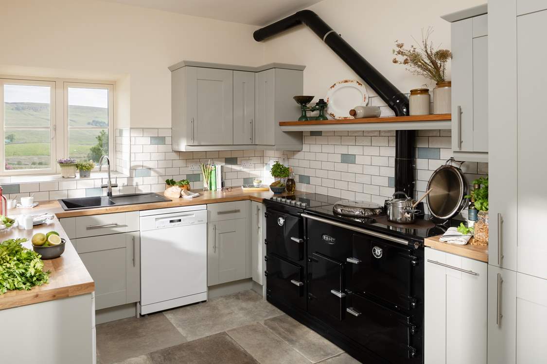 A beautiful contemporary kitchen/diner with amazing views (the oil-fired Aga is ornamental only).