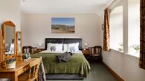 The large windows let in lots of sunlight to this cosy bedroom with a 'zip and link' bed.