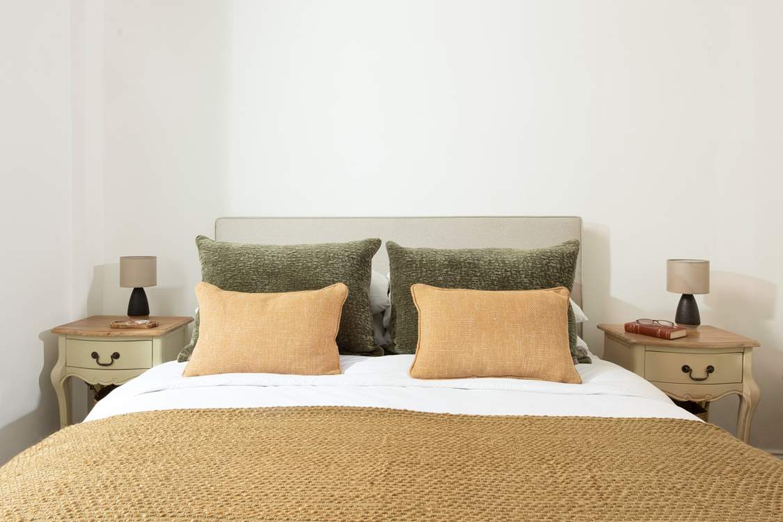 Snuggle under the covers of the comfy king-size bed.