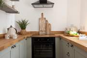 The charming galley kitchen is equipped with all the essentials.