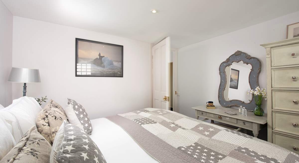 Gentle shades of grey and cream in the third bedroom.
