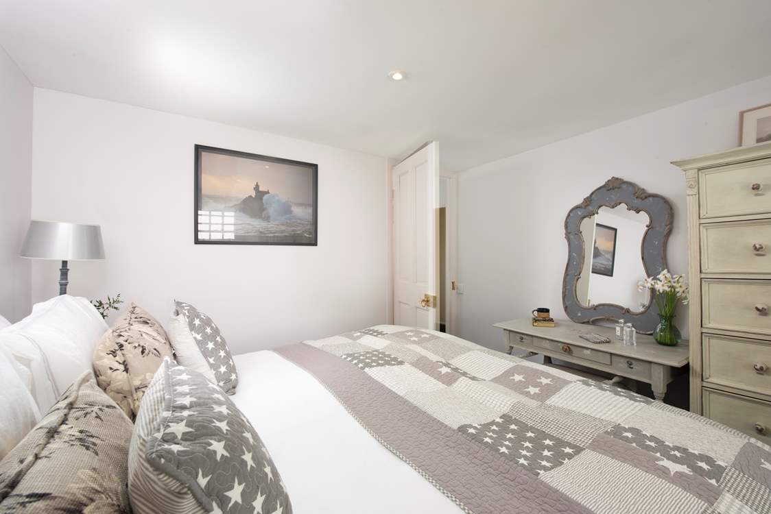 Gentle shades of grey and cream in the third bedroom.