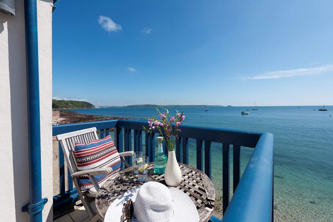 Patio doors lead from from the sitting-room out to the little balcony, a wonderful spot to sit out and enjoy the setting from sunrise to sunset.