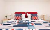 Bedroom 1 is wonderfully patriotic with its red, white and blue decor.  - Thumbnail Image