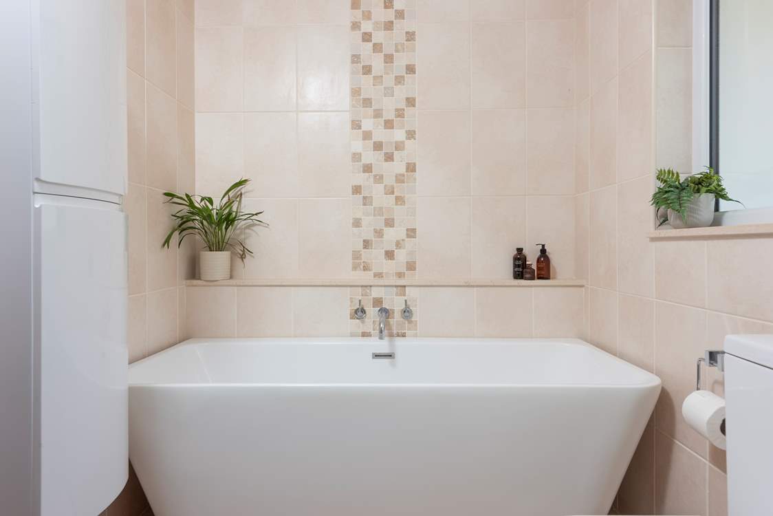 The family bathroom sits on the ground floor with a free-standing bath......