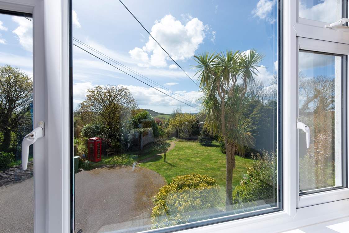 The view from bedroom 4 looks over the front garden stretching out to Helman Tor. (Please note the telephone box is purely ornamental).