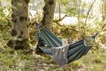 Gently sway in the hammock woven between the trees.
