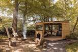 The dreamy alfresco space features a fire pit and undercover kitchen-diner.