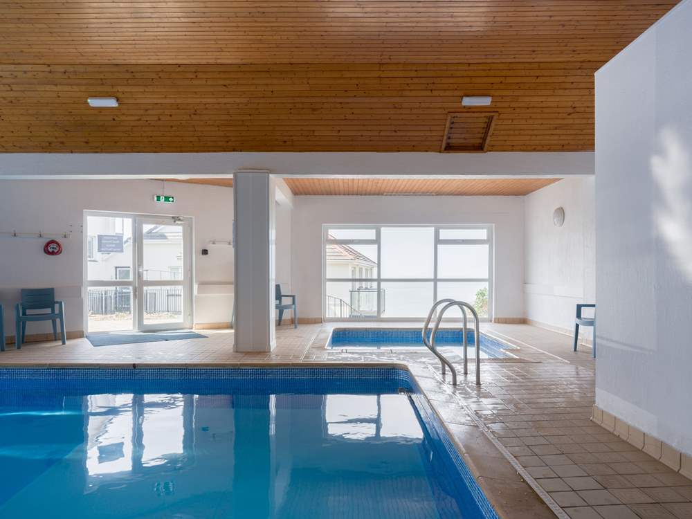 The communal pool offers the perfect spot for a morning swim before a coastal walk.