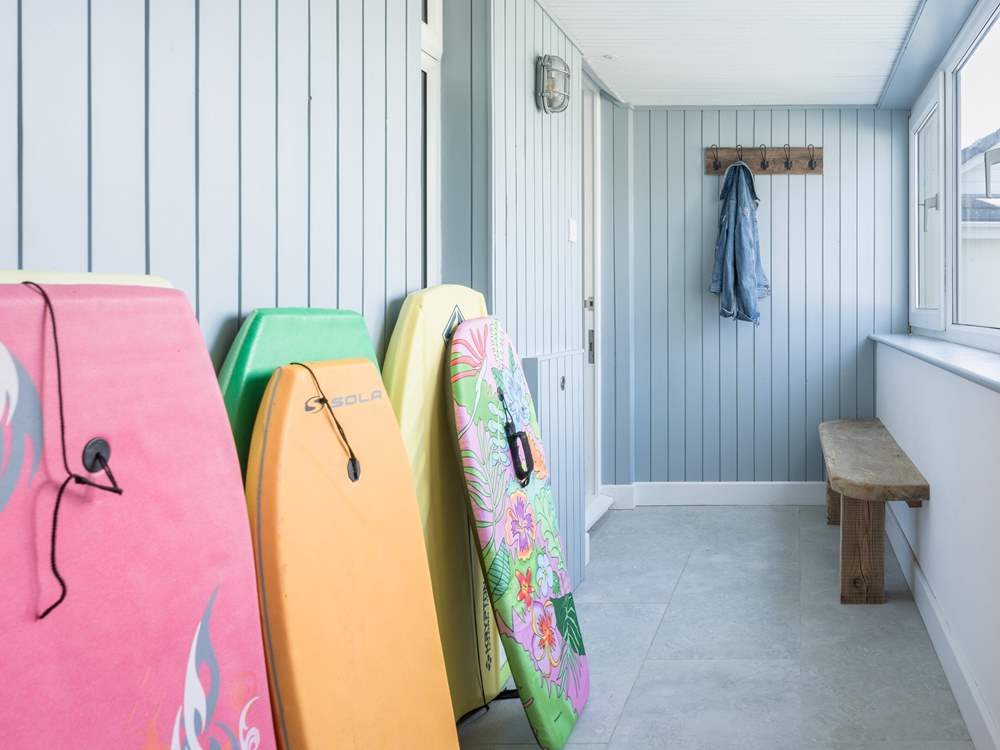 The entrance hall doubles up as board storage before entering the apartment.