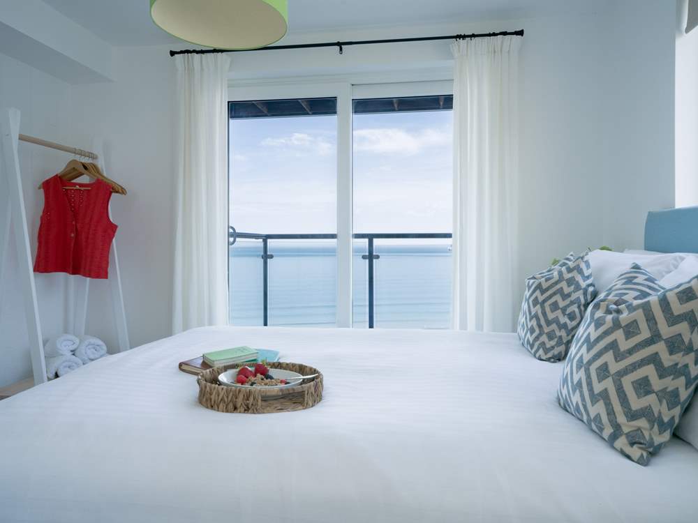 Bedroom 1 enjoys a balcony, sea views and an en suite shower-room.