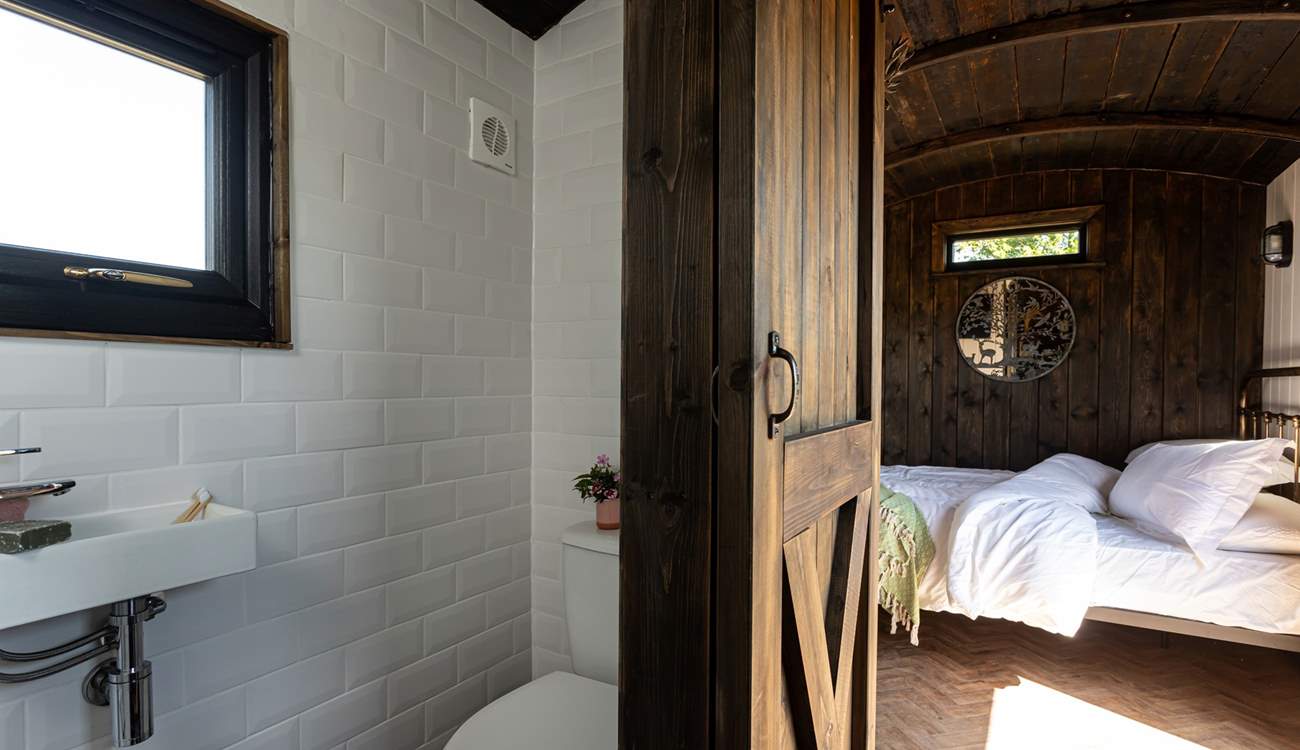 You'll find the en-suite shower room tucked to the right of the kitchen. 