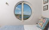 The innovative porthole windows frame the ocean view (coverings for night time are in situ). - Thumbnail Image