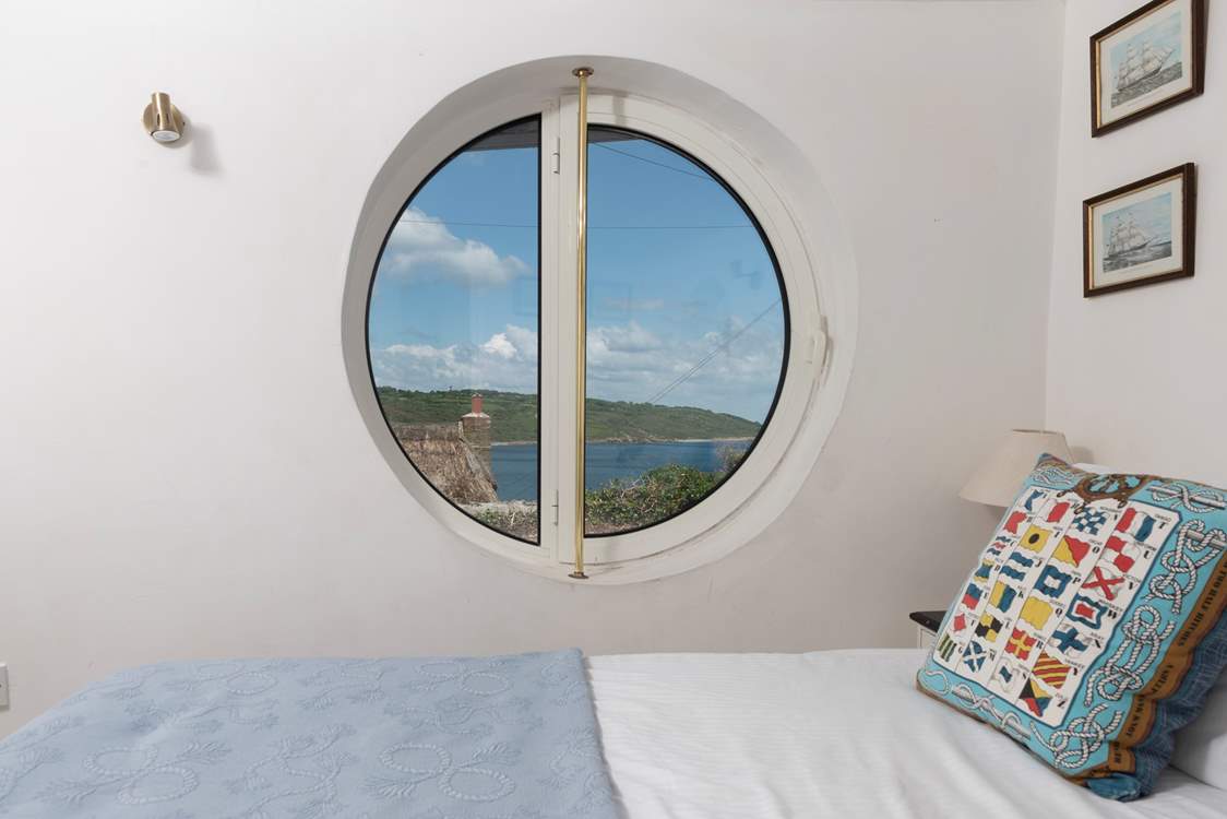 The innovative porthole windows frame the ocean view (coverings for night time are in situ).