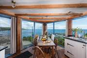 The kitchen/diner boasts panoramic sea views.