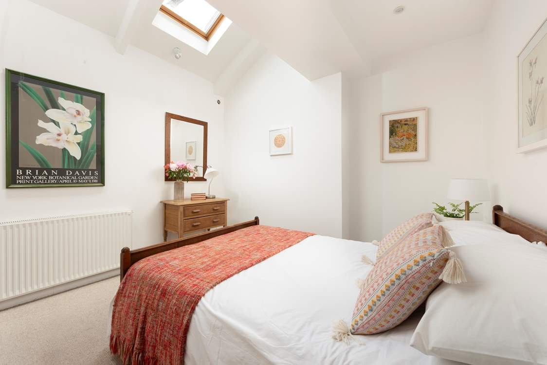 Bedroom 2 is filled with light from Velux windows above.