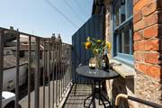 A pretty balcony off the living space is the perfect spot to sit back and plan your day. Please note the balcony can only sit two lucky guests!