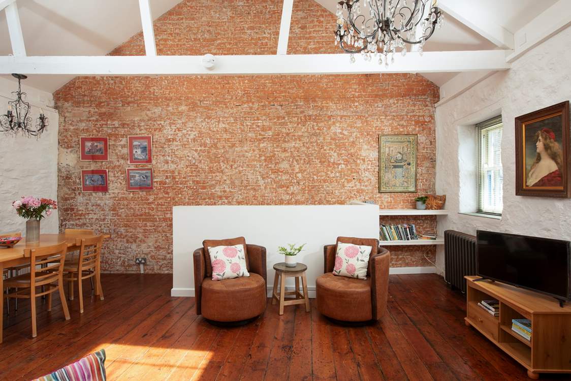 Beautiful high ceilings upstairs with exposed brickwork gives this home an industrial feel.