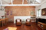 Beautiful high ceilings upstairs with exposed brickwork gives this home an industrial feel.